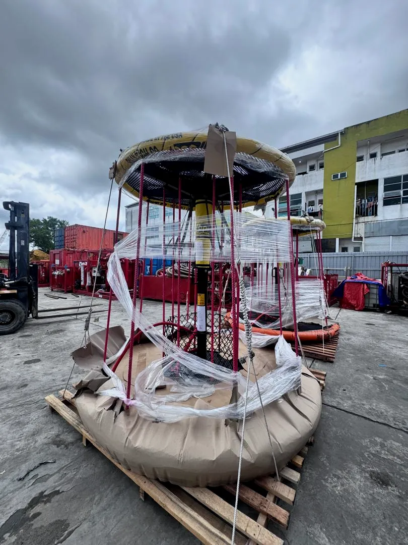 Personnel transfer basket wrapped in plastic on a timber pallet in a yard