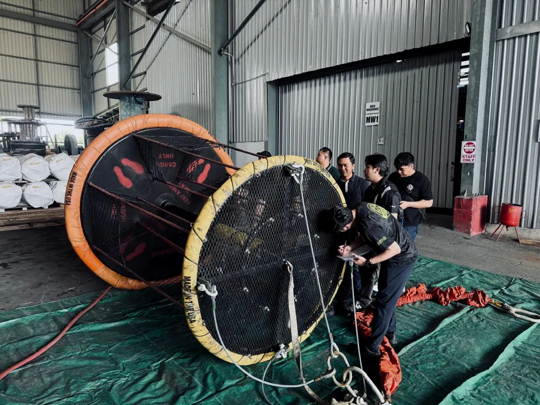 Era Harvest crew inspecting two personnel transfer baskets during operational training
