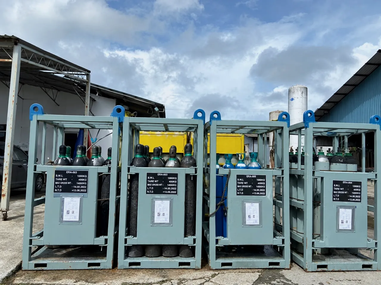 Industrial gas cylinder racks lined up in a yard