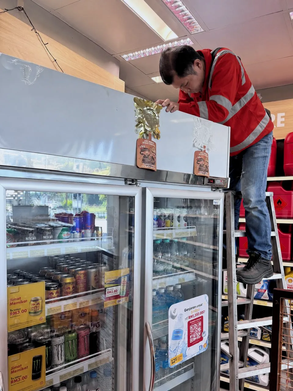 Technician servicing a chiller unit inside a shop
